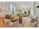 Bright living room with tiled floors, neutral decor, and lots of natural light at 6816 Greengrove Blvd, Clermont, FL 34714