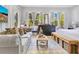 Comfortable combined living room and bedroom space features plush seating, soft natural light and a bed at 6816 Greengrove Blvd, Clermont, FL 34714