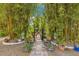 Scenic walkway lined with bamboo, garden benches, and lush greenery, creating a serene outdoor space at 6816 Greengrove Blvd, Clermont, FL 34714