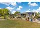 Relaxing outdoor patio area with comfortable seating, lush potted plants, and scenic backyard views at 6816 Greengrove Blvd, Clermont, FL 34714