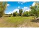 Expansive backyard featuring a sprawling lawn and trees, offering a serene and natural outdoor space at 6816 Greengrove Blvd, Clermont, FL 34714