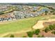 Aerial view of the community with several homes backing onto the golf course at 7928 Jacks Club Dr, Kissimmee, FL 34747