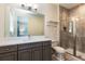 Modern bathroom with a large mirror, a vanity, and a glass-enclosed shower at 7928 Jacks Club Dr, Kissimmee, FL 34747