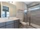 Updated bathroom with a gray vanity, a large mirror, and a glass-enclosed shower at 7928 Jacks Club Dr, Kissimmee, FL 34747