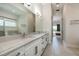 Bright bathroom featuring double vanity with marble countertop and tile floors at 7928 Jacks Club Dr, Kissimmee, FL 34747