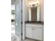Pool-side bathroom featuring a vanity with modern countertop and a large mirror offering a view to the pool area at 7928 Jacks Club Dr, Kissimmee, FL 34747