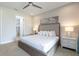 Bright bedroom featuring neutral tones, a ceiling fan, and access to an ensuite bathroom at 7928 Jacks Club Dr, Kissimmee, FL 34747