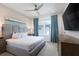 Well-lit bedroom offers a TV, ceiling fan, large window, and tasteful furnishings at 7928 Jacks Club Dr, Kissimmee, FL 34747