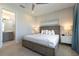 Comfortable bedroom with a ceiling fan and an open doorway to an ensuite bathroom at 7928 Jacks Club Dr, Kissimmee, FL 34747