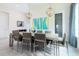 Bright dining room featuring a modern table, stylish light fixtures, and an open floor plan at 7928 Jacks Club Dr, Kissimmee, FL 34747