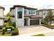 Modern two-story home with a two-car garage and stone accents at 7928 Jacks Club Dr, Kissimmee, FL 34747