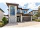 Contemporary two-story home with a brick driveway and modern architectural details at 7928 Jacks Club Dr, Kissimmee, FL 34747