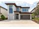 Contemporary two-story home with a brick driveway and modern architectural details at 7928 Jacks Club Dr, Kissimmee, FL 34747