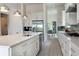 Bright modern kitchen featuring stainless steel appliances, island with sink, and stylish pendant lighting at 7928 Jacks Club Dr, Kissimmee, FL 34747