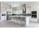 Open concept kitchen with stainless steel appliances, large island, and modern white cabinetry at 7928 Jacks Club Dr, Kissimmee, FL 34747
