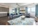 Spacious living room features a large sectional sofa, modern rug, and wet bar at 7928 Jacks Club Dr, Kissimmee, FL 34747