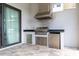 This outdoor kitchen features a stainless steel grill, countertop, storage, and beverage refrigerator at 7928 Jacks Club Dr, Kissimmee, FL 34747