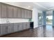Convenient wet bar with gray cabinetry, quartz countertop, and drink cooler at 7928 Jacks Club Dr, Kissimmee, FL 34747
