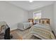 Cozy bedroom with twin beds, neutral walls, and a window at 8107 Coconut Palm Way # 102, Kissimmee, FL 34747