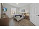 Well-lit bedroom with wood floors, television, and double hung window at 8107 Coconut Palm Way # 102, Kissimmee, FL 34747