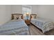 Bright bedroom with twin beds and a nightstand between them at 8107 Coconut Palm Way # 102, Kissimmee, FL 34747