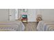 Neutral toned bedroom with twin beds, TV and decorative chair at 8107 Coconut Palm Way # 102, Kissimmee, FL 34747