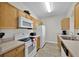 Bright kitchen with white appliances, wood cabinets, and laminate countertops at 8107 Coconut Palm Way # 102, Kissimmee, FL 34747