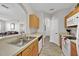 Kitchen featuring laminate countertops, wood cabinets and a double sink basin at 8107 Coconut Palm Way # 102, Kissimmee, FL 34747