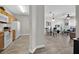 Open concept living and dining area with wood floors and view of the kitchen at 8107 Coconut Palm Way # 102, Kissimmee, FL 34747