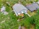 Aerial view of the home featuring a metal roof, wood deck, and lush backyard in a residential neighborhood at 811 Laurel Ave, Orlando, FL 32803