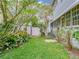 Landscaped backyard featuring green grass, a small storage shed, and a white fence for privacy at 811 Laurel Ave, Orlando, FL 32803