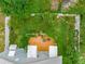 Aerial view of backyard with wood deck, chairs, and lush landscaping surrounded by a white fence at 811 Laurel Ave, Orlando, FL 32803