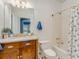 Bright bathroom features a single sink vanity and shower-tub combination with tiled walls at 811 Laurel Ave, Orlando, FL 32803