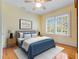 Bedroom with a queen bed, hardwood floors, and a large window at 811 Laurel Ave, Orlando, FL 32803