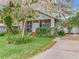 Charming home featuring a lush front yard, mature landscaping and a inviting entryway with a screened porch at 811 Laurel Ave, Orlando, FL 32803