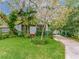 Charming home featuring a lush front yard, mature landscaping and a inviting entryway with a screened porch at 811 Laurel Ave, Orlando, FL 32803
