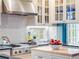 Bright kitchen features stainless hood, tiled backsplash, and sleek countertops at 811 Laurel Ave, Orlando, FL 32803