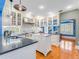 Bright kitchen with white cabinetry, stainless steel appliances, and black countertops at 811 Laurel Ave, Orlando, FL 32803