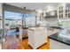 Open-concept kitchen boasts island, stainless appliances, and access to dining room at 811 Laurel Ave, Orlando, FL 32803