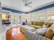 Comfortable living room has hardwood floors, blue walls, and ceiling fan at 811 Laurel Ave, Orlando, FL 32803
