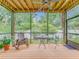 Charming screened porch features wood floors, ceiling fan, and garden views at 811 Laurel Ave, Orlando, FL 32803