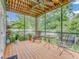 Inviting screened porch with wood floors, ceiling fan, and views of the lush, landscaped backyard at 811 Laurel Ave, Orlando, FL 32803