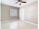 Bright bedroom with neutral walls, tile floors, a ceiling fan, and a double-door closet at 844 Rosalia Dr, Sanford, FL 32771