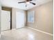 Bedroom with tile flooring, a ceiling fan, closet with sliding doors, and window with blinds at 844 Rosalia Dr, Sanford, FL 32771