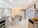Bright dining area with modern light fixture, seating for four and decorative barn door at 844 Rosalia Dr, Sanford, FL 32771