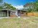 Cozy home with a covered carport and front porch enhanced by a wooden fence at 844 Rosalia Dr, Sanford, FL 32771
