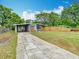 Home offers a spacious driveway leading to covered parking and a quaint front porch at 844 Rosalia Dr, Sanford, FL 32771