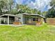 Charming single-story home featuring a covered carport and front porch, enhanced by a well-manicured lawn at 844 Rosalia Dr, Sanford, FL 32771
