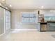 Open kitchen features stylish barn doors and a stainless steel dishwasher at 844 Rosalia Dr, Sanford, FL 32771