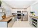 Well-lit kitchen with butcher block countertops, stainless steel appliances, and white and grey cabinets at 844 Rosalia Dr, Sanford, FL 32771